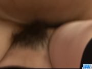 Dark girl with hair in a bun gets a facial from a white guy
